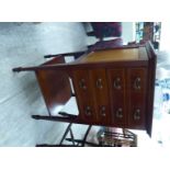 An Edwardian ebony and string inlaid mahogany music cabinet with four drawers, raised on square,