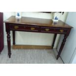A late Victorian mahogany side table, raised on ring turned,