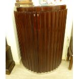 A Ralph Lauren mahogany finished freestanding bow front bar with a pair of fluted panelled doors,