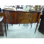 An early 19thC mahogany breakfront serving sideboard with a central drawer,