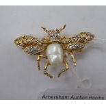 An 18ct gold winged insect brooch, set with a pearl,