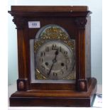 A late 19thC German oak cased mantel clock with reed carved flanks,