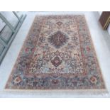 A Persian design carpet with a central diamond motif,