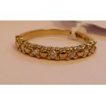 A 9ct gold diamond set half-eternity ring 11