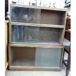 A 1920s light oak finished Minty three glazed section bookcase,