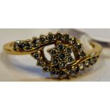 An 18ct gold diamond set crossover cluster ring 11