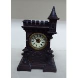 An early 20thC Black Forest stained wooden cased mantel clock of castle tower design;