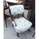 An early 20thC oak framed nursing chair, the fabric covered back and seat raised on ring turned,