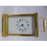 A modern Mappin & Webb lacquered brass cased carriage timepiece with bevelled glass panels and a