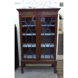 An early 20thC mahogany bookcase with a pair of glazed doors, enclosing four fixed shelves,