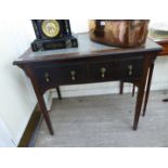 An early 20thC mahogany two drawer writing table,