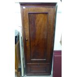 A late Victorian flame mahogany finished hallrobe with a moulded cornice, over a panelled door,