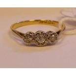 An 18ct gold three stone claw set diamond ring 11
