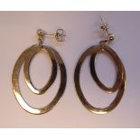 A pair of silver double oval hoop drop earrings 11
