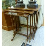 A modern nesting set of three crossbanded mahogany occasional tables,