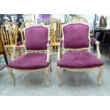 A pair of modern Continental style washed cream stained and carved showwood framed salon chairs
