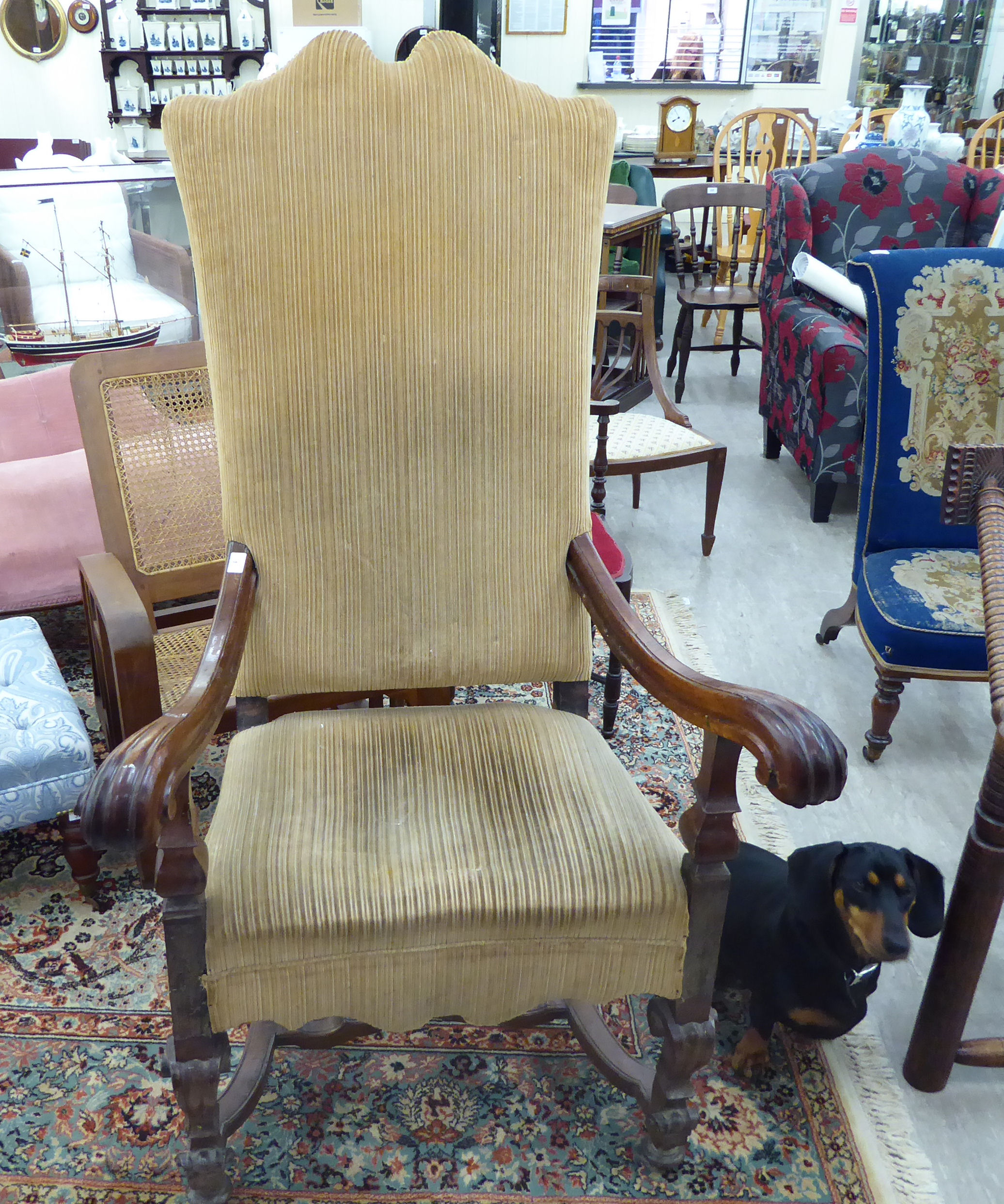 A late 19thC Continental walnut framed hall chair with a high back and open, scrolled arms,