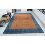 A modern woollen carpet with a central orange panel,