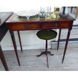 A modern mahogany finished two drawer writing table, raised on slender, turned,