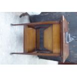 An Edwardian mahogany sewing table, the twin flap top enclosing a part-fitted interior,