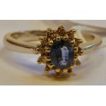 A 9ct bi-coloured gold claw set sapphire and diamond cluster ring 11