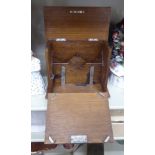A 1920s oak deskstand with a hinged lid and a fall flap, enclosing a part-fitted interior 8''h 8.