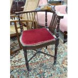 An Edwardian inlaid mahogany framed corner chair with a level,