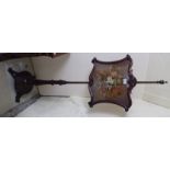 A William IV rosewood pole screen with a shaped floral tapestry panel, on a tapered column,