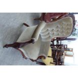 A late Victorian mahogany framed salon chair with a button upholstered green fabric back and