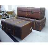 A graduated set of three early 20thC beech and canvas bound cabin trunks largest 12''h 36''w