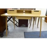 An Ercol modern light oak writing desk with two drawers, raised on square,