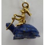 A lapis lazuli and 9ct gold pendant, featuring an imp,