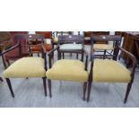 Three similar Regency mahogany framed open arm chairs, each with a bar back and swept open arms,