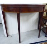 An early 19thC string inlaid mahogany demi-lune tea table,