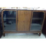 An Art Deco 'Bath Cabinet Makers' crossbanded mahogany display cabinet with a central door,