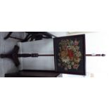 An early Victorian mahogany polescreen, the height adjustable, rectangular,