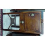 A George III mahogany washstand, the twin flaps enclosing a fitted interior,