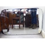 A 1930s unframed and slice cut mirror with canted corners 19'' x 29'' LSM