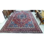 A Persian carpet with a central serpentine outline central motif,