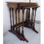 A modern nesting set of three walnut occasional tables,