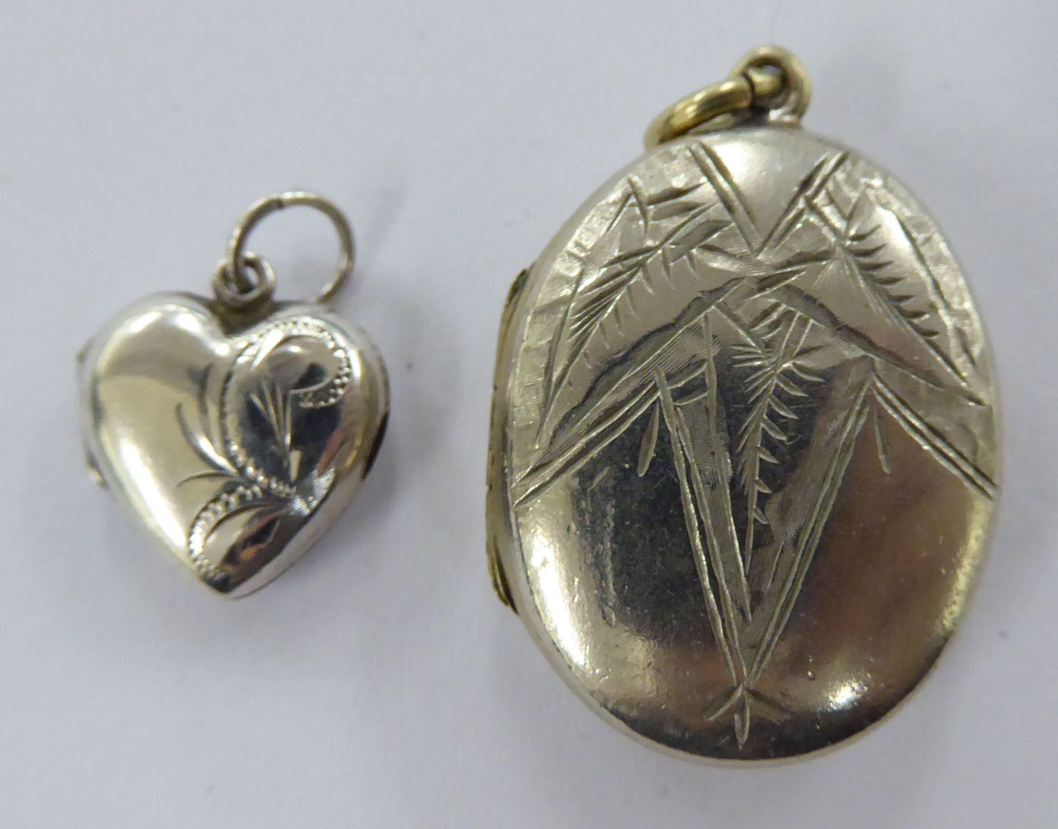 Two dissimilar white metal lockets, viz.