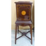 An Edwardian mahogany torchere with a box section top, raised on splayed,