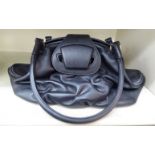 A Smythson black hide handbag with a purple fabric lining OS6