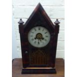 A late 19thC American mahogany and walnut veneered mantel clock with a pointed arched case,
