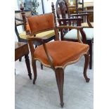 An Edwardian rosewood framed salon chair with an orange coloured fabric upholstered back and seat,