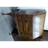 A 1930s walnut bureau with a fall front, over a brushing slide and two graduated drawers,