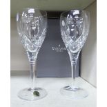 A pair of Waterford crystal Lismore 50th Anniversary stemmed wine glasses with the original carton