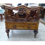 A William IV rosewood and stained beech framed three division Canterbury, over a single drawer base,