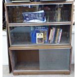 A 1920s Minty light oak finished three glazed section bookcase,