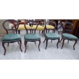 A set of four late Victorian walnut framed balloon back dining chairs,